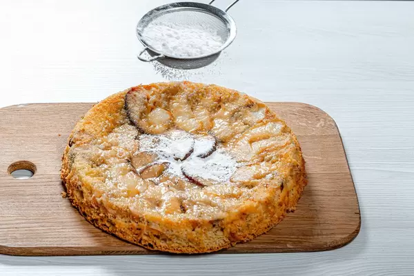 Ready homemade apple pie sprinkled with powdered sugar