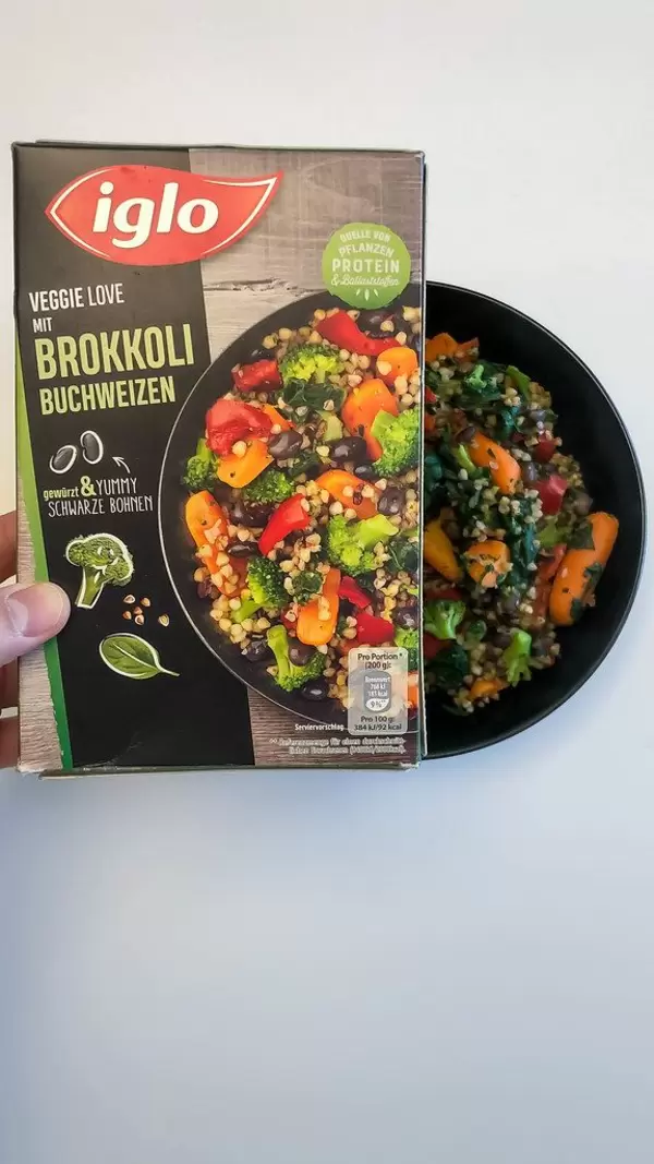 Ready-made vegan meal by Iglo: Veggie love with broccoli and buckwheat served in a black bowl on white background