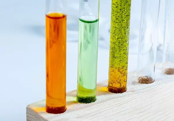 Reagenzgläser mit verschiedenen Indikator-Flüssigkeiten in einem Holzständer Nahaufnahme
