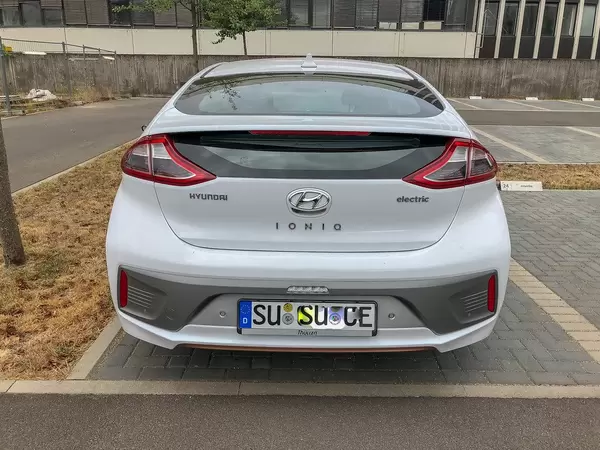 Rear view of mid-size electric car Hyundai Ioniq in a parking spot