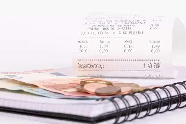 Receipt and Euro money on notebook