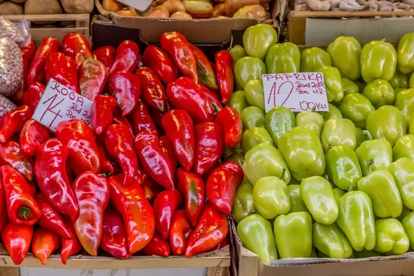 Red and green paprikas on marketplace