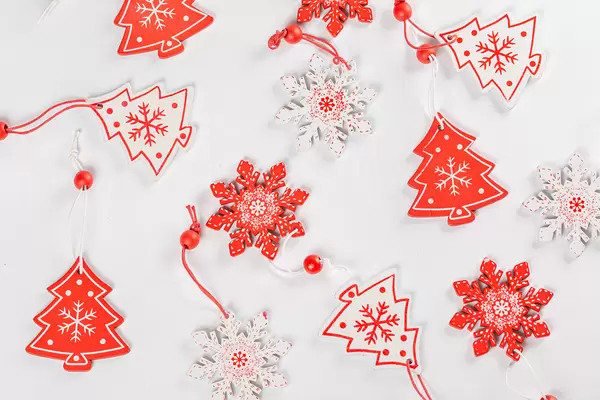 Red and white wooden Christmas decor on white background