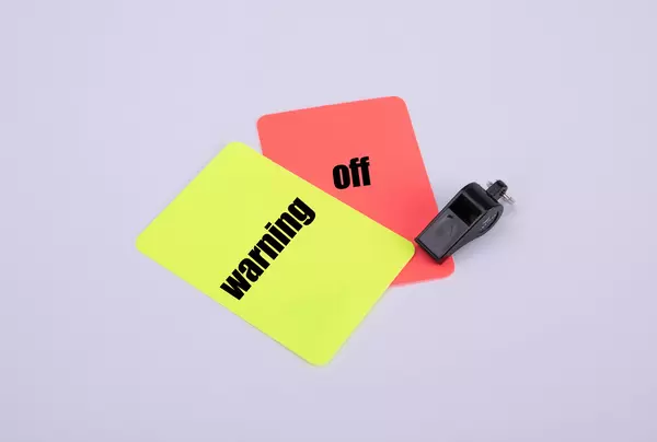 Red and yellow referee cards with Warning and off text