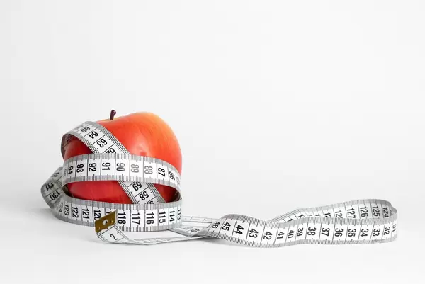 Red apple and measuring tape