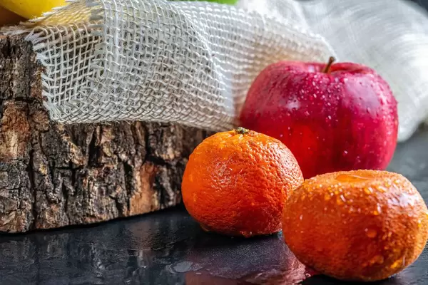 Red apple and tangerines with water drops on dark background (Flip 2019)
