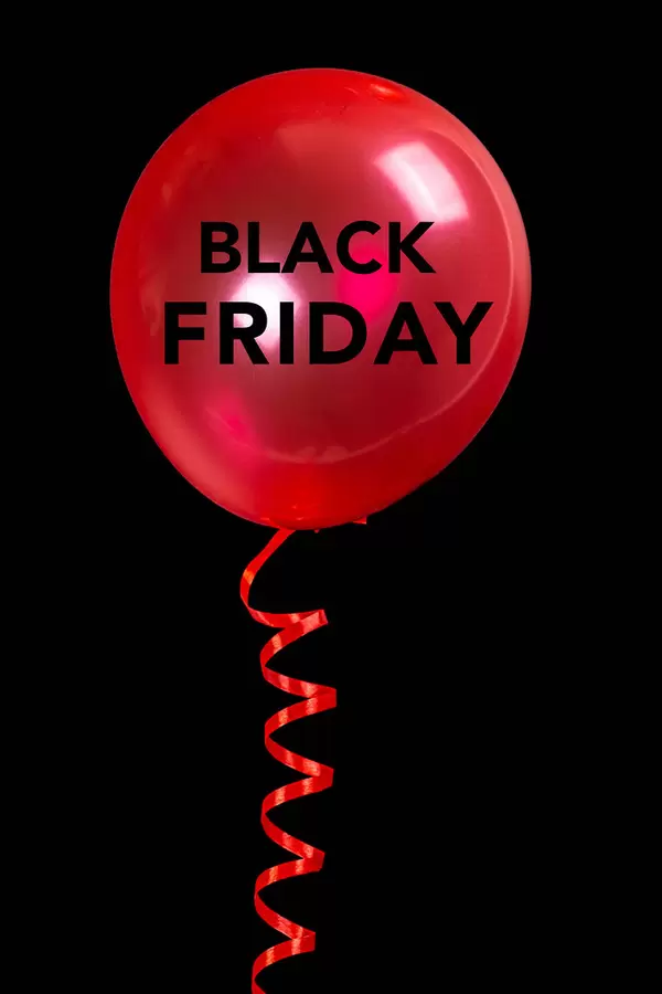 Red balloon on black background, black friday concept