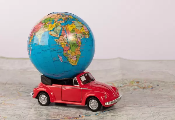 Red beetle car with globe on map (Flip 2019)