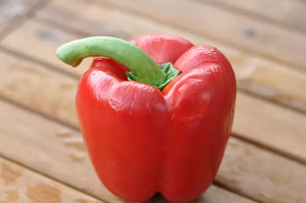 Red bell pepper on wooden table