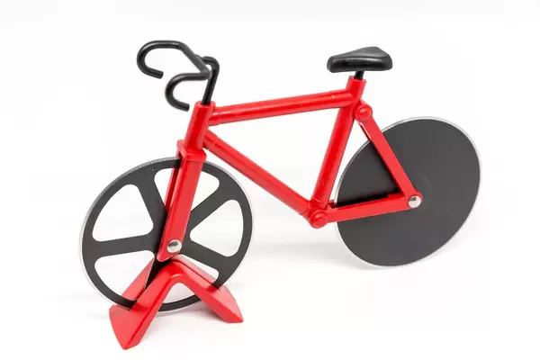 Red bicycle pizza knife on white background