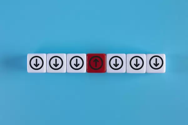 Red block with arrow facing individual pointing in the different way on blue background