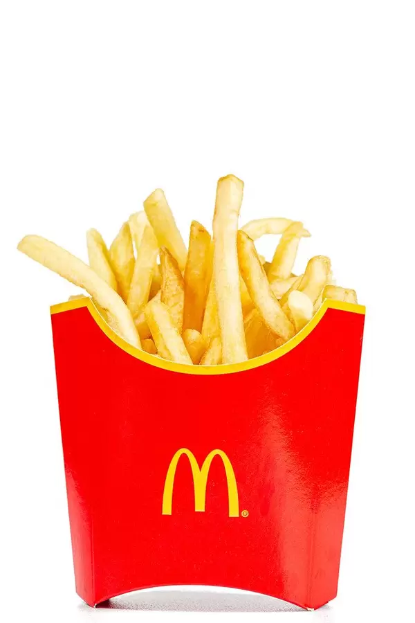Red box full of French fries on white background
