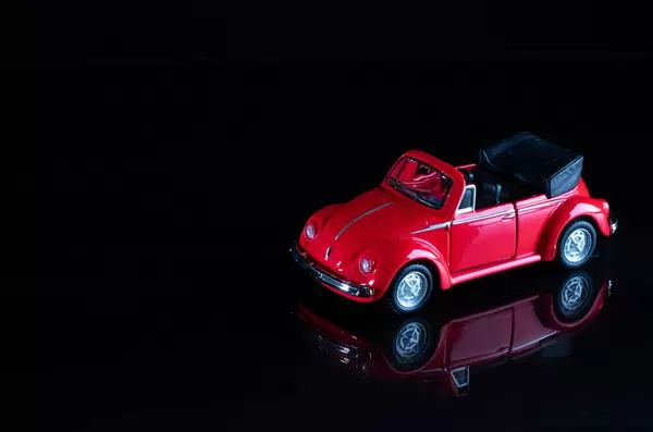 Red cabriolet car on black background