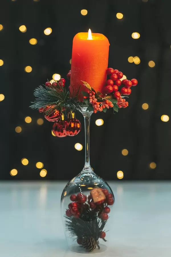 Red candle with candlestick on night background with bokeh