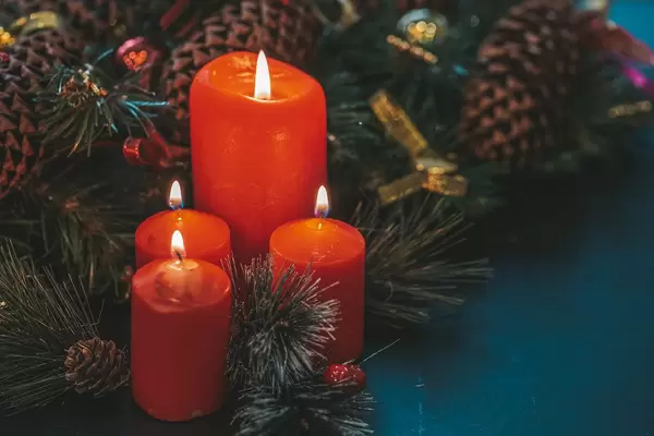 Red candles on dark background with Christmas tree branches (Flip 2019)