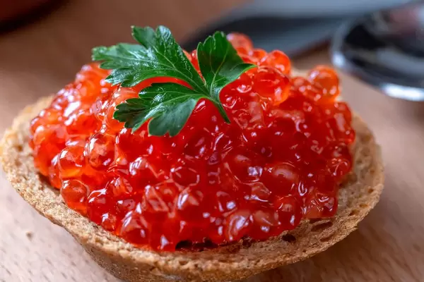 Red caviar on black bread