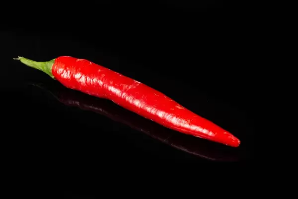 Red Chilli Hot Pepper above black background (Flip 2019)