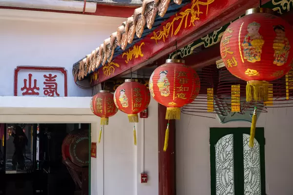 Red Chinese Lantern with Golden Letters and Incense Cones with Wishes hanging inside Phuc Kien Pagodda at the Assembly Hall of Fujian Chinese in Hoi An, Vietnam