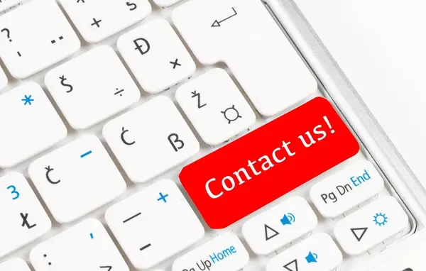 Red Contact us button on white keyboard