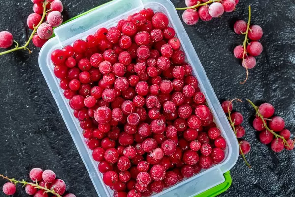 Red currant berries on black background