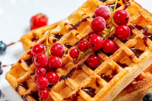 Red currant on waffles with chocolate topping close-up (Flip 2019)