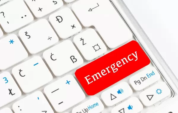 Red emergency button on white keyboard