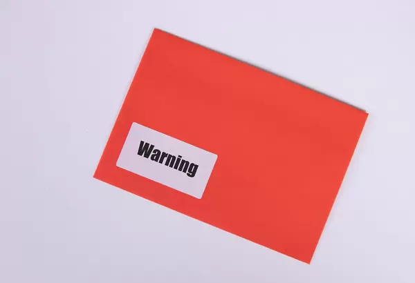 Red envelope with Warning text on white background