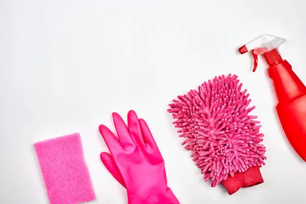 Red house cleaning products on white background