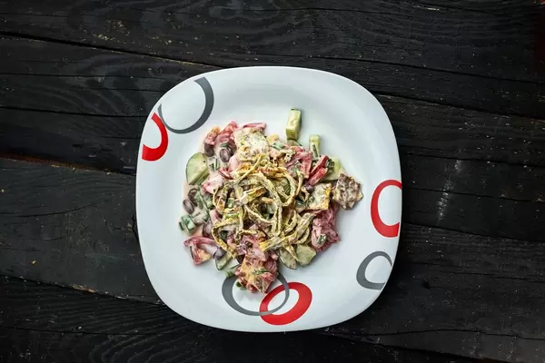 Red kidney bean salad with freshly baked omelet slices on dark wood background