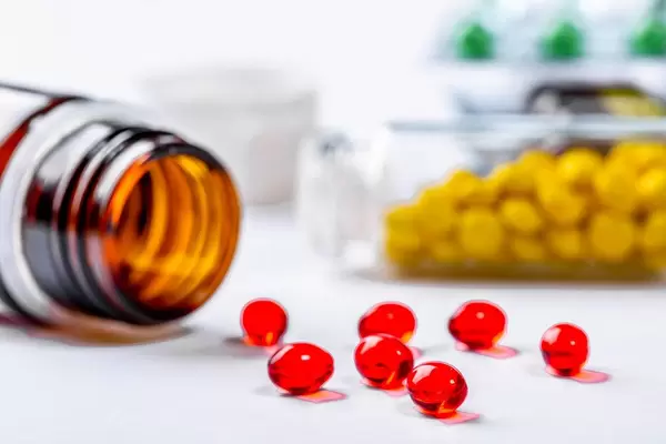 Red medical capsule close up