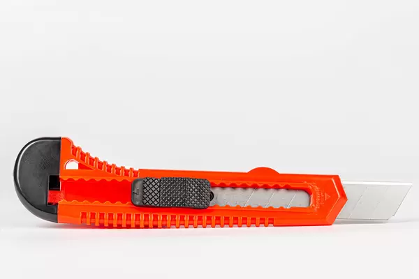 Red office knife on white background