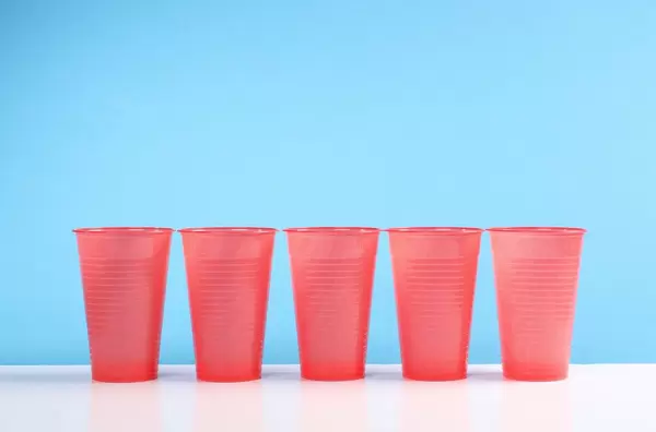 Red plastic cups on the blue background