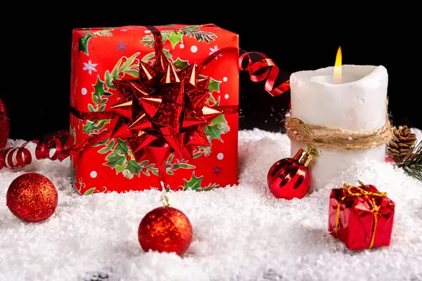 Red present box with candle and xmas decor