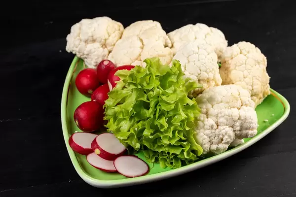 Red Radishes Lettuce and Cauliflower on the plate