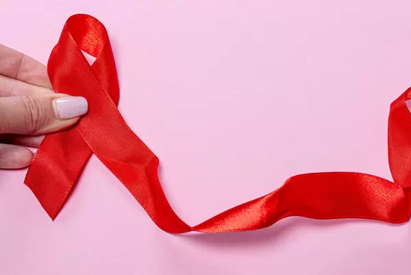 Red ribbon on pink background, symbol world aids day (Flip 2019)