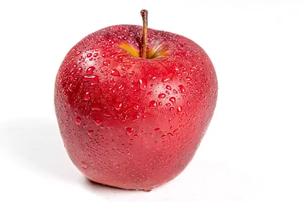 Red ripe apple with drops of water