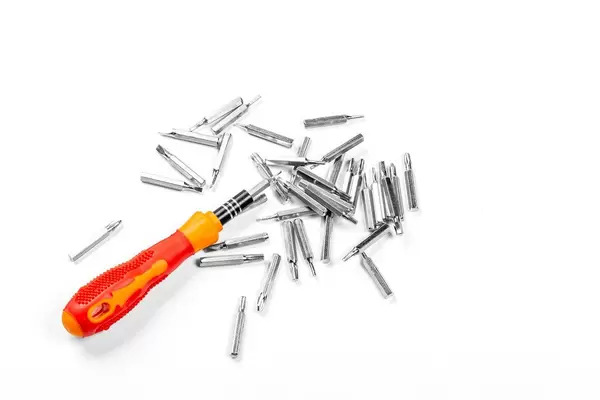 Red screwdriver with different attachments on a white background (Flip 2020)