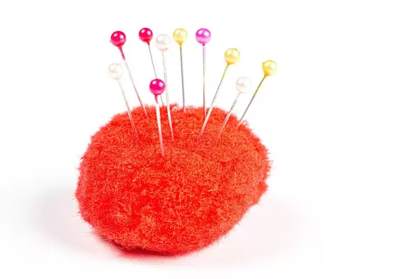 Red small needle pad on white background