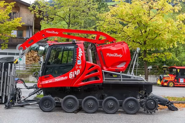 Red snow groomer in Alpbach: PistenBully 600 for preparing ski slopes