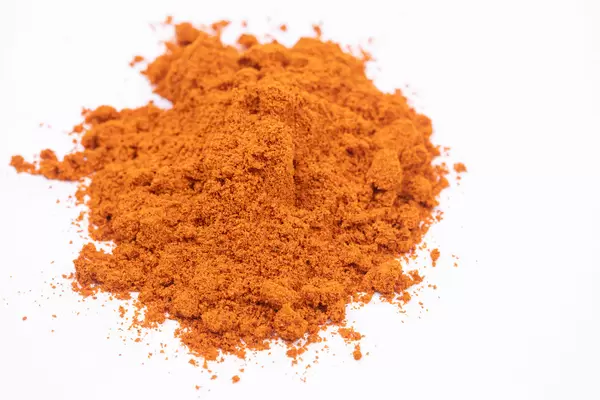 Red spicy Paprika powder on the white background