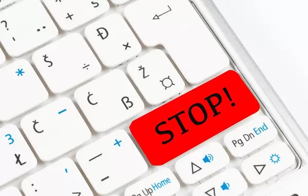 Red stop button on white keyboard