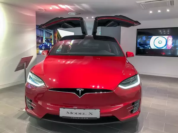 Red Tesla Model X with wing doors