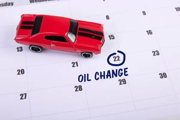 Red toy car and Oil Change text on the calendar