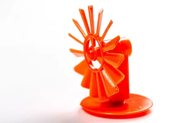 Red toy mill on white background (Flip 2019)