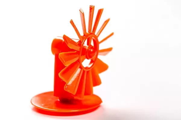 Red toy mill on white background