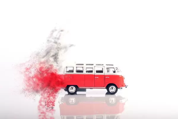 Red vintage camper van moving fast