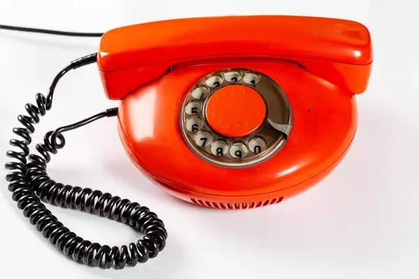 Red vintage phone on white background