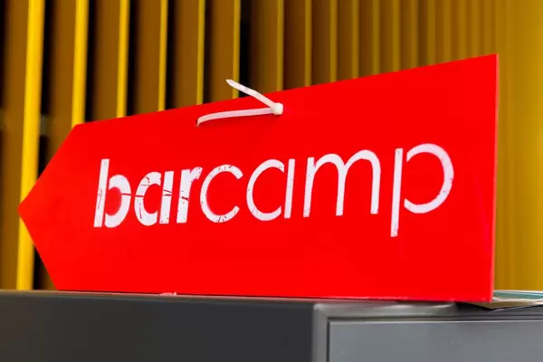 Red-white arrow and entrance sign for German Barcamp in Wiesbaden