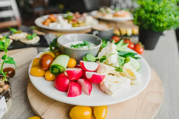 Redish Plate With Veggies And Sauce