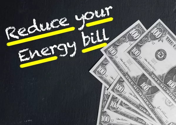 Reduce your Energy bill text with US dollar banknotes